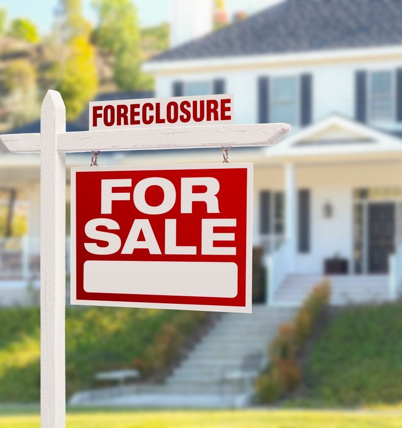 Foreclosure Home For Sale Sign in Front of Large House